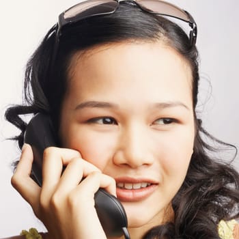 Close-up of a young woman on the phone and looking sideways