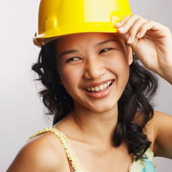 Close-up of a young woman wearing a hardhat and smiling