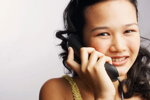Portrait of a young woman on the phone and smiling