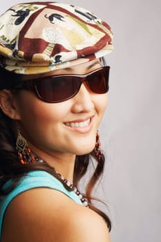 Portrait of a young woman wearing sunglasses and smiling