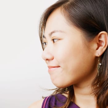 Close-up of a young woman smirking