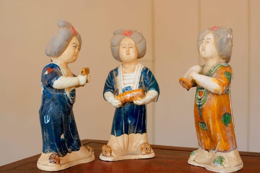 Close-up of three figurines on a table