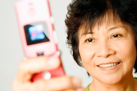 Close-up of a mature woman holding a mobile phone