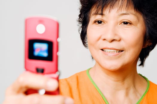 Close-up of a mature woman holding a mobile phone