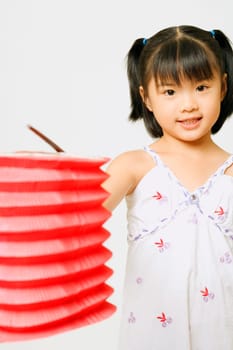 Portrait of a girl standing and holding a Chinese lantern