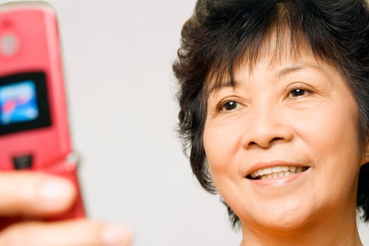 Close-up of a mature woman holding a mobile phone