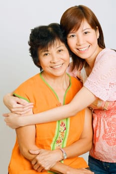 Portrait of a young woman embracing her mother