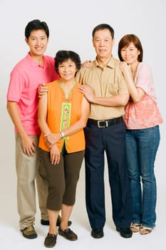 Portrait of a young couple standing with their parents