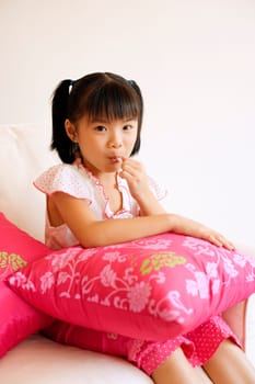 Portrait of a girl eating a lollipop
