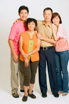 Portrait of a young couple standing with their parents