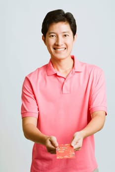 Portrait of a young man holding a greeting card