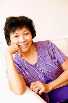 Portrait of a mature woman sitting on a couch