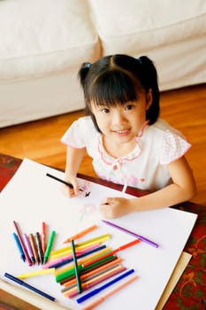 Portrait of a girl drawing in a coloring book