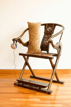 Cushion with headphones on a folding chair