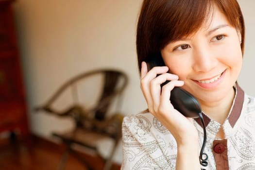 Close-up of a young woman talking on the telephone