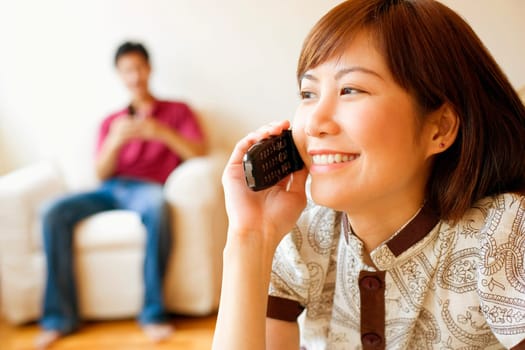 Close-up of a young woman talking on a mobile phone and smiling