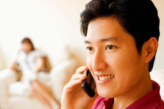 Close-up of a young man talking on a mobile phone and smiling
