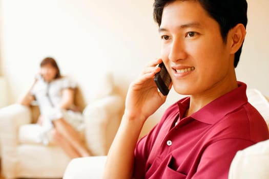 Close-up of a young man talking on a mobile phone and smiling