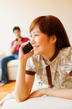 Close-up of a young woman talking on a mobile phone and smiling