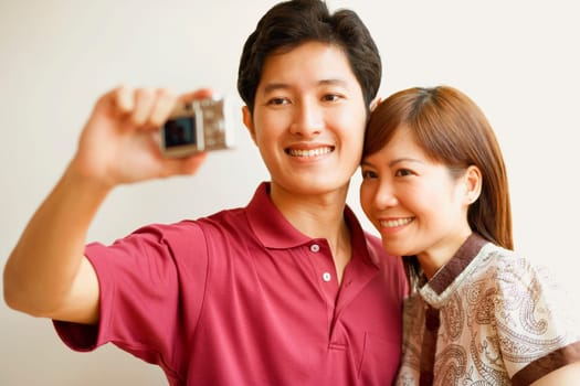Young couple taking a picture of themselves