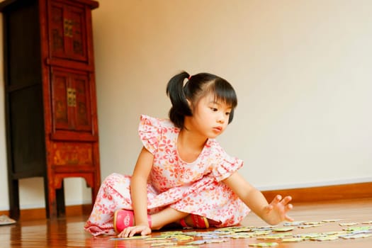 Close-up of a girl sitting on the floor