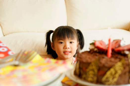 Close-up of a girl looking at a cake