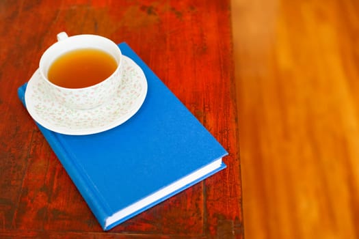 Close-up of a cup on a diary