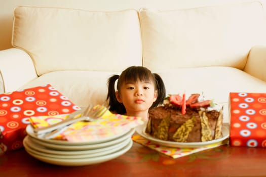 Girl looking at a cake