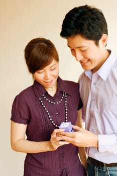 Close-up of a young couple looking at a ring