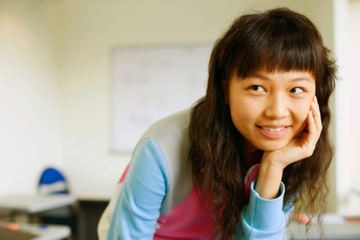 Close-up of a young woman smiling in the classroom