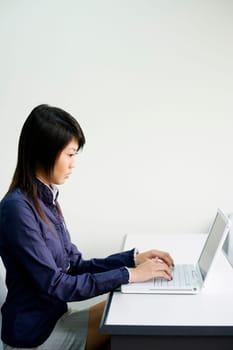 Close-up of a young woman using a laptop