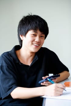 Portrait of a boy smiling and holding a calculator