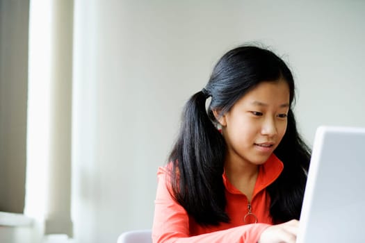 Close-up of a girl using a laptop