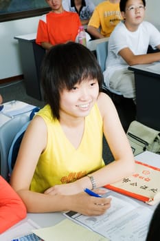 High angle view of a teenage girl sitting in the classroom