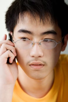 Close-up of a boy talking on mobile phone