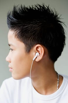Side profile of a boy listening to headphones