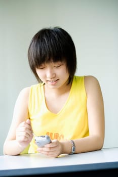 Close-up of a girl operating a mobile phone