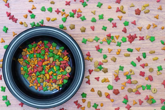 Top view dry cat food in bowl on wooden background