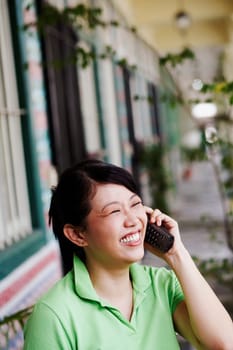 Close-up of a young woman talking on a cordless phone