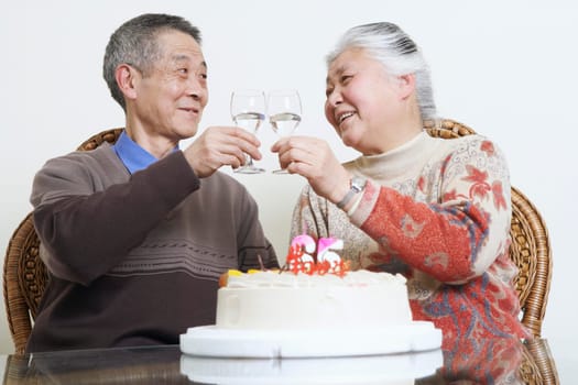 Close-up of a senior couple toasting with wine glasses