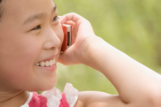 Close-up of a girl talking on a mobile phone and smiling