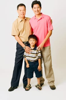 Portrait of a senior man with his son and granddaughter