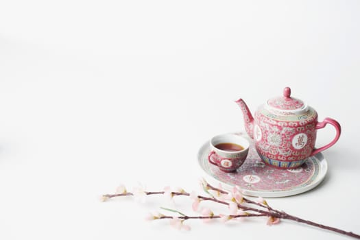 High angle view of a cup of black tea and a teapot on a tray