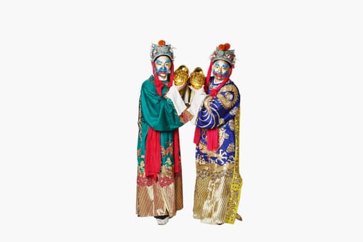 Portrait of two male Chinese opera performers holding bowls full of gold coins