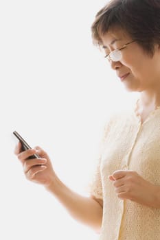 Close-up of a mature woman text messaging