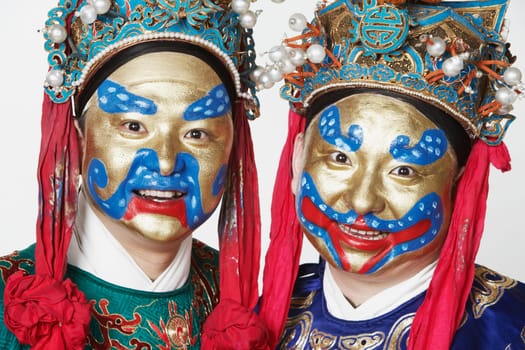 Portrait of two male Chinese opera performers smiling