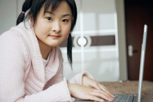 Portrait of a young woman using a laptop