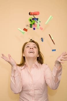Close-up of a mid adult woman tossing stationery objects