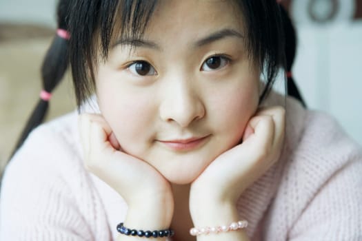 Portrait of a young woman with her hand on her chin