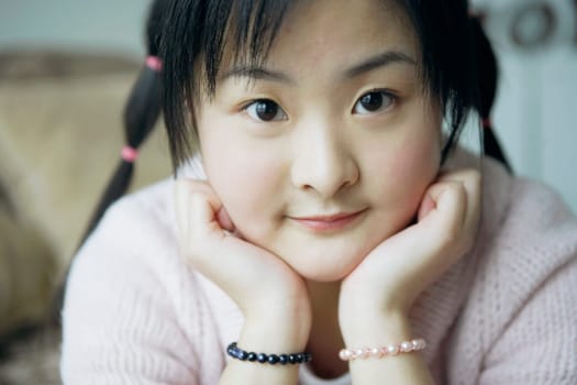 Portrait of a young woman with her hand on her chin